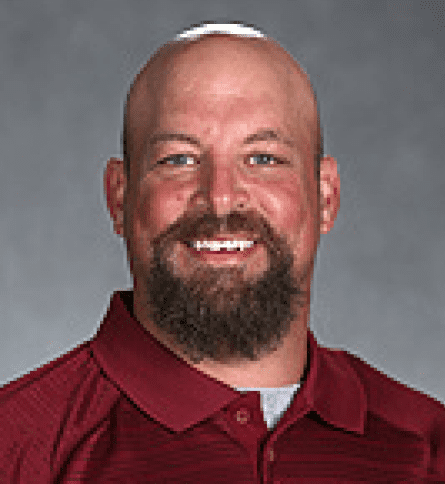 A man with a beard and red shirt