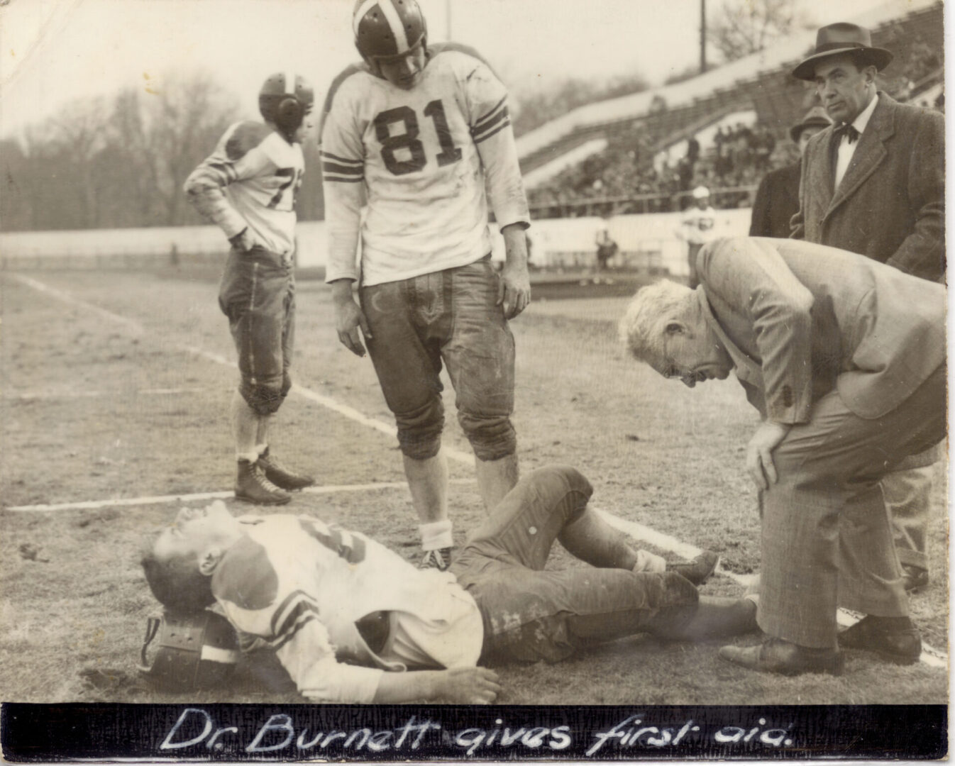 A football player laying on the ground with his head down.