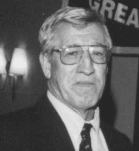 A man in suit and tie wearing glasses.