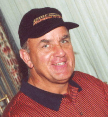 A man wearing a hat and smiling for the camera.