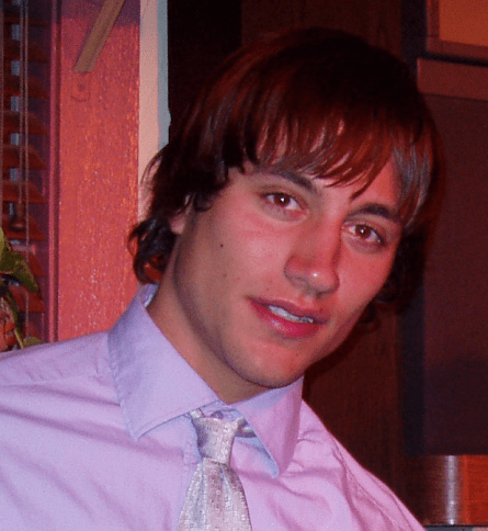 A man with long hair and wearing a tie.