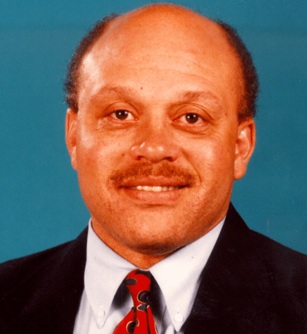 A man with a beard and mustache wearing a suit