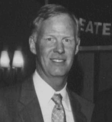 A black and white photo of a man in suit