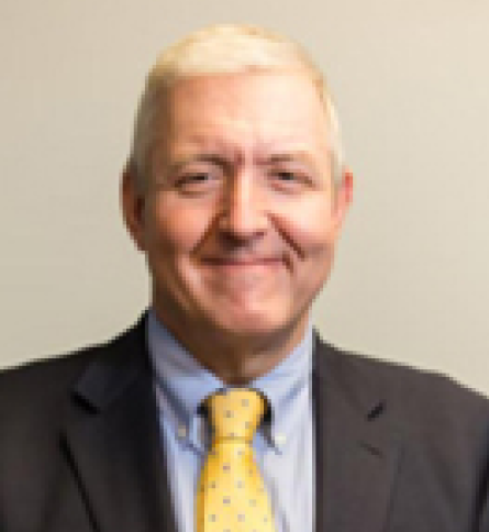 A man with blonde hair and a suit and tie.