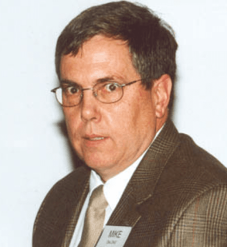 A man in a suit and tie wearing glasses.