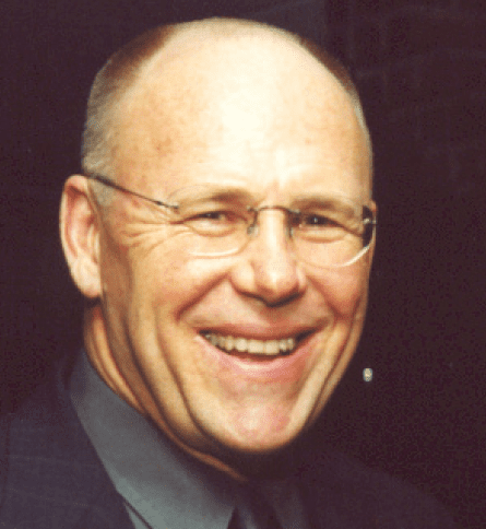 A man with glasses smiling for the camera.