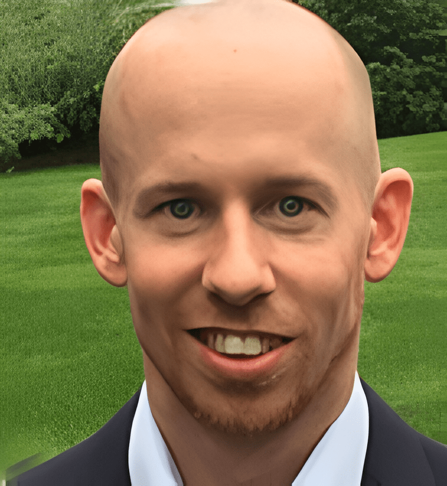 A man with bald head and wearing suit.