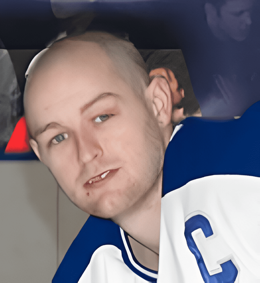 A bald man with shaved head and baseball uniform.