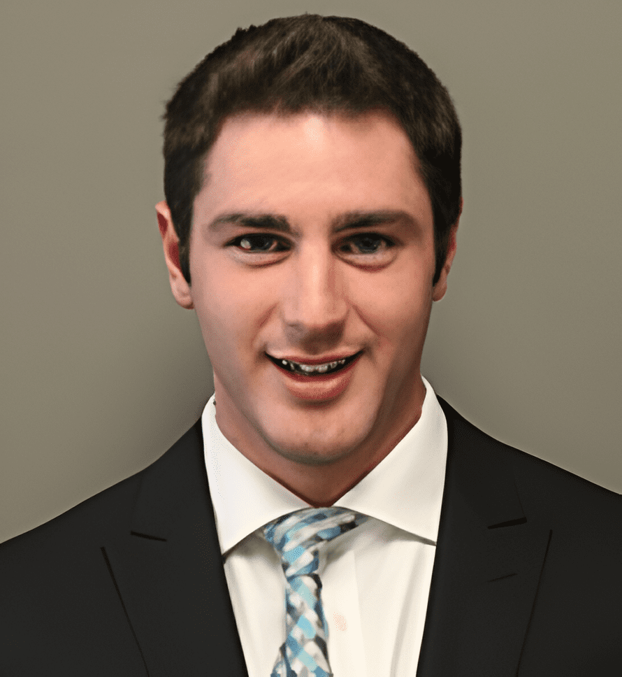 A man in suit and tie smiling for the camera.