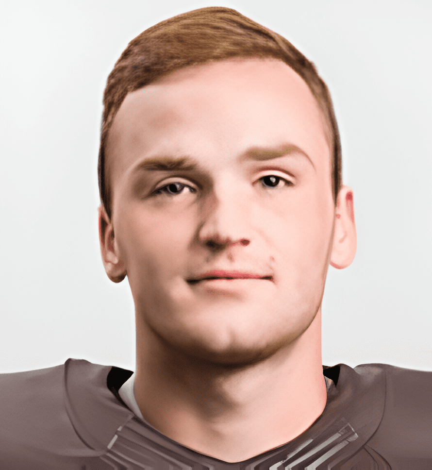 A man with brown hair and a football uniform.