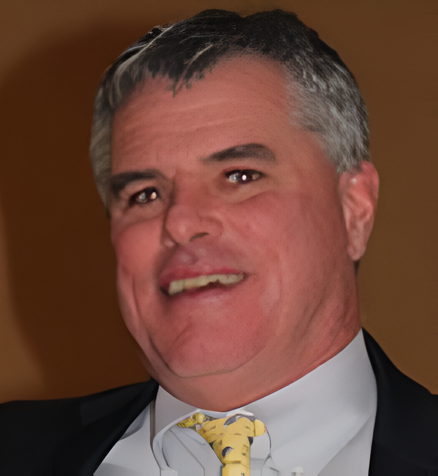 A man in suit and tie smiling for the camera.