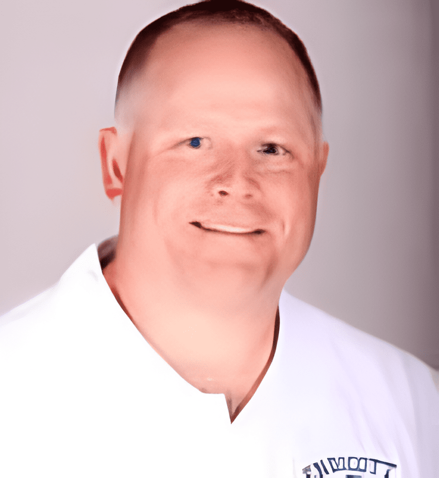 A man in white shirt smiling for the camera.