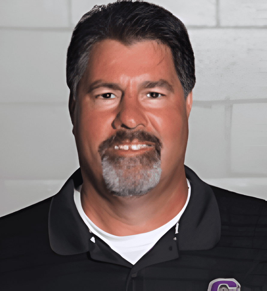 A man with a beard and mustache wearing a black shirt.