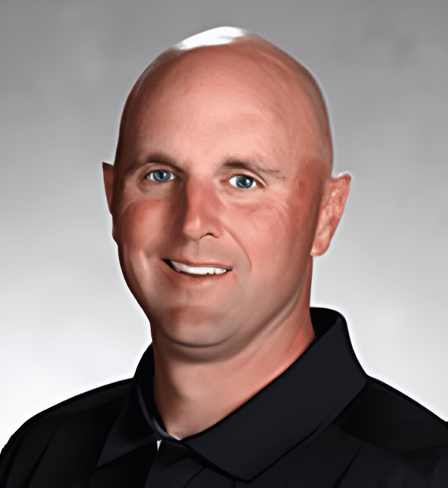 A man with bald head and black shirt.