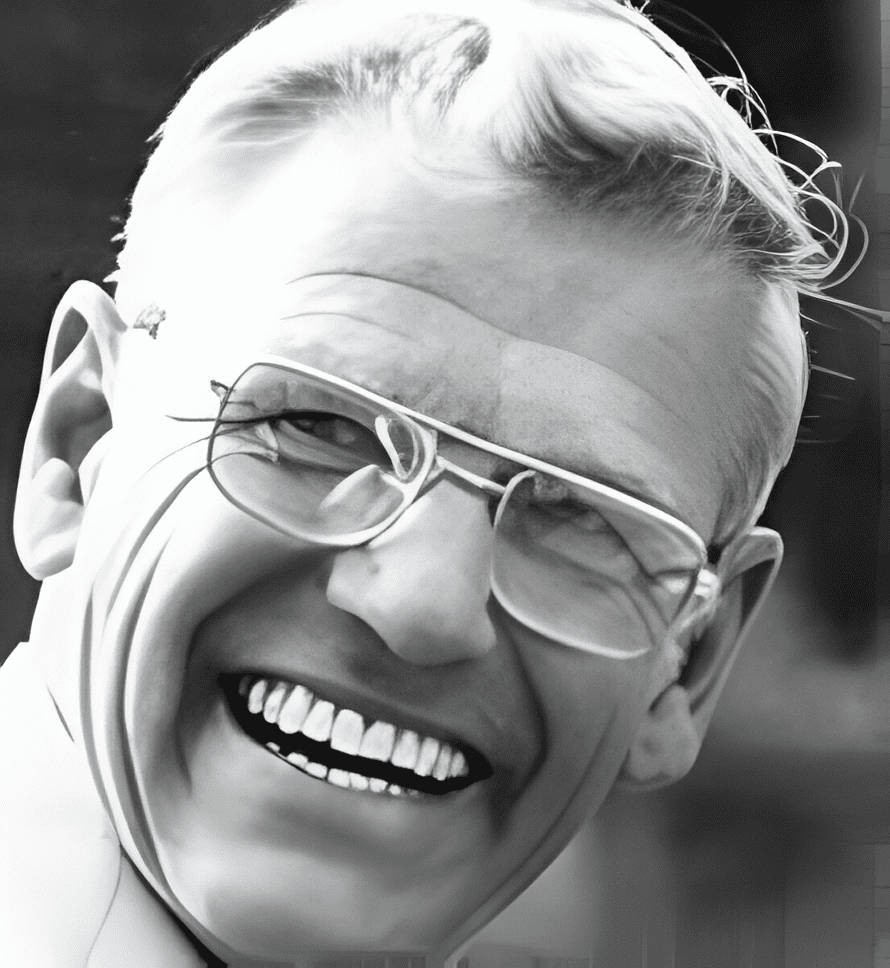 A man with glasses smiling for the camera.