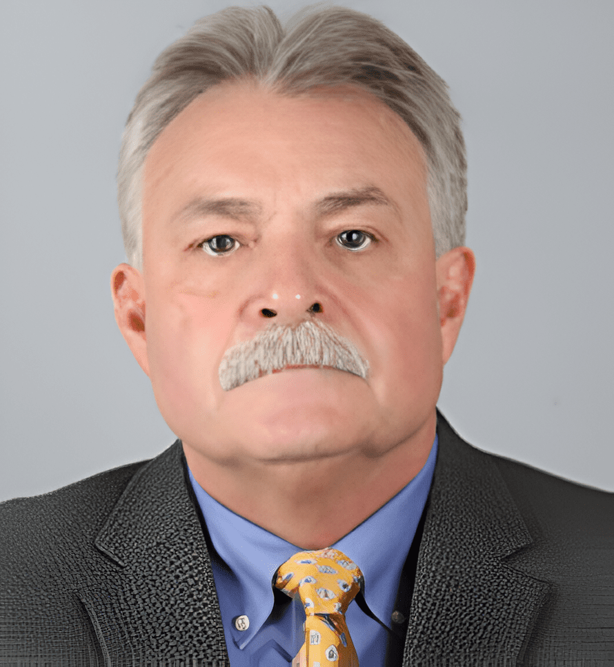 A man with gray hair and mustache wearing a suit.