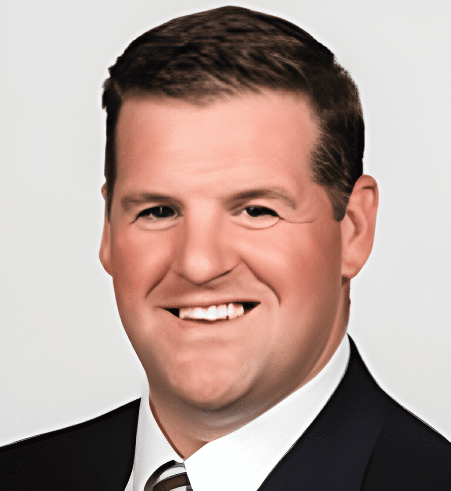 A man in suit and tie smiling for the camera.