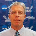 A man with glasses and a tie