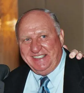 A man with a beard and mustache wearing a suit