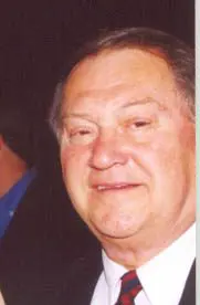 A man with a white shirt and blue tie.